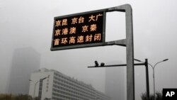 2018年11月14日,中国首都被雾霾笼罩,屏幕显示几条高速公路关闭。当局当天发布了北京重度空气污染的黄色警报。(美联社)