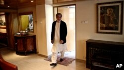 Afghan presidential candidate Abdullah Abdullah arrives for an interview with The Associated Press at his residence in Kabul, April 13, 2014.